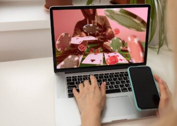 Man watching football online broadcast on his laptop and celebrate victory in betting at bookmaker's website. Betting concept. High quality photo
