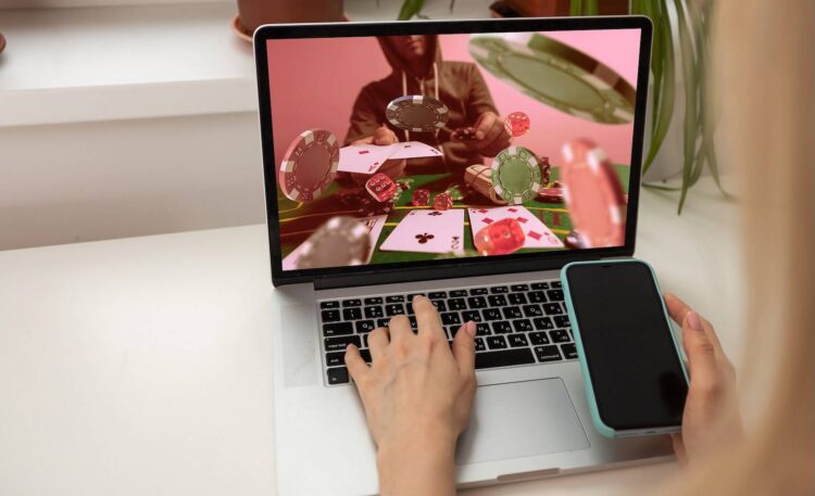 Man watching football online broadcast on his laptop and celebrate victory in betting at bookmaker's website. Betting concept. High quality photo